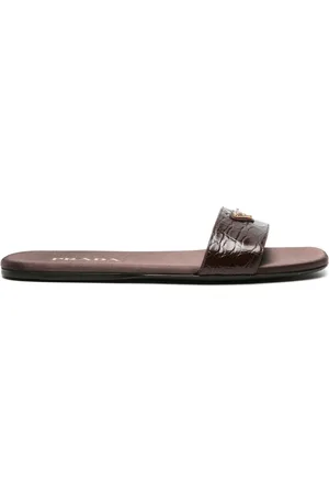 Prada Krokodilpräglade tofflor med logotyp