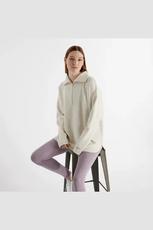 New Balance Kvinnor Tech Knit Oversized Half Zip i Beige Poly sticka